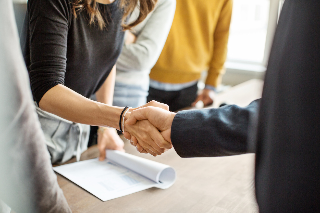 Buy sell plans: Close up of business people shaking hands in office.